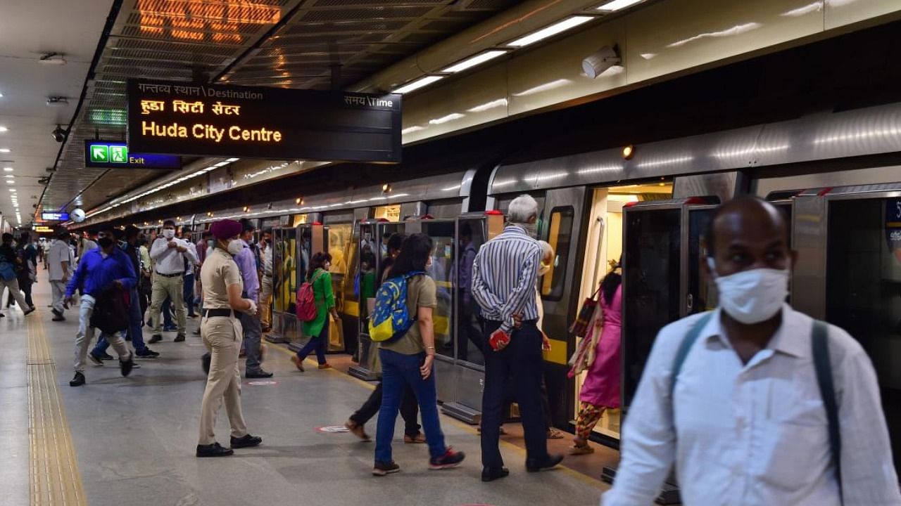 Passengers board a metro train in new Delhi. Credit: PTI File Photo