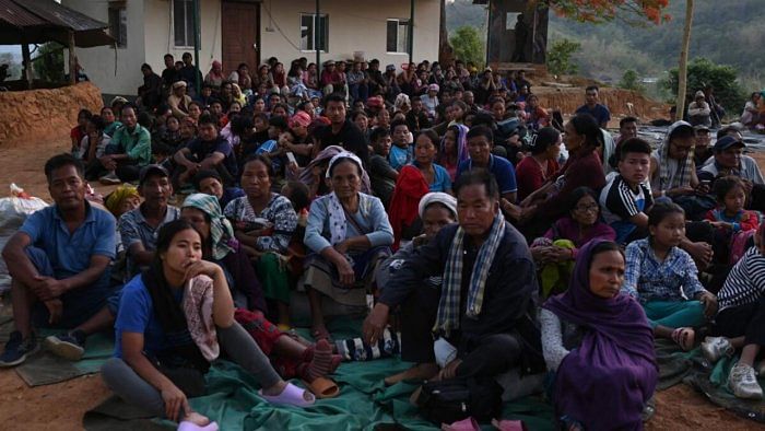 People wait at a temporary shelter in a military camp in Manipur. Credit: AFP Photo  