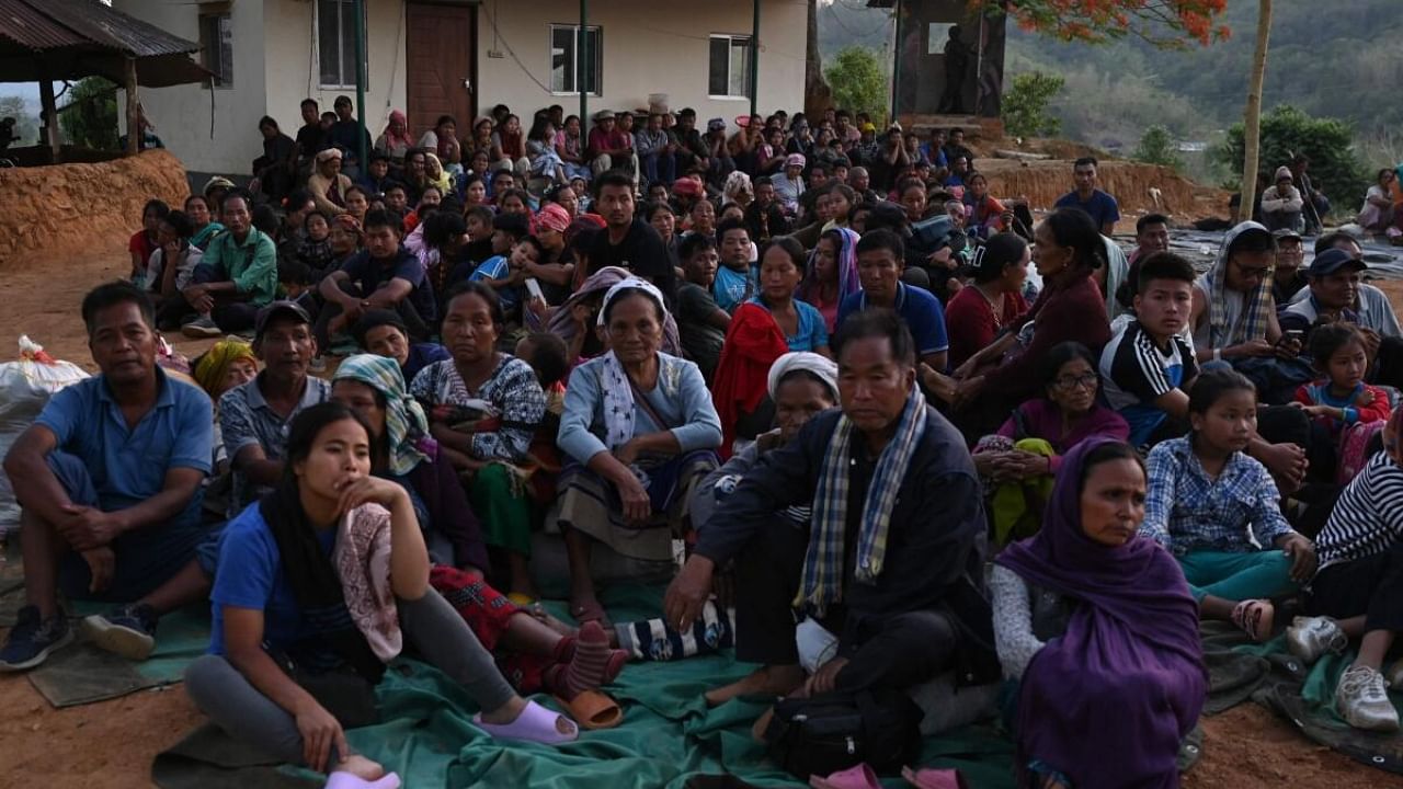 People wait at a temporary shelter in a military camp in Manipur. Credit: AFP Photo