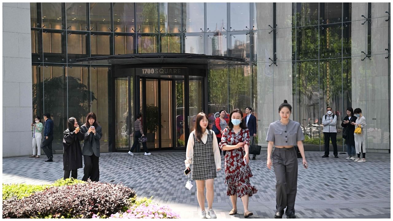 People walk past the entrance of the building where Canada's consul general facilities are located in Shanghai on May 9, 2023. Credit: AFP Photo