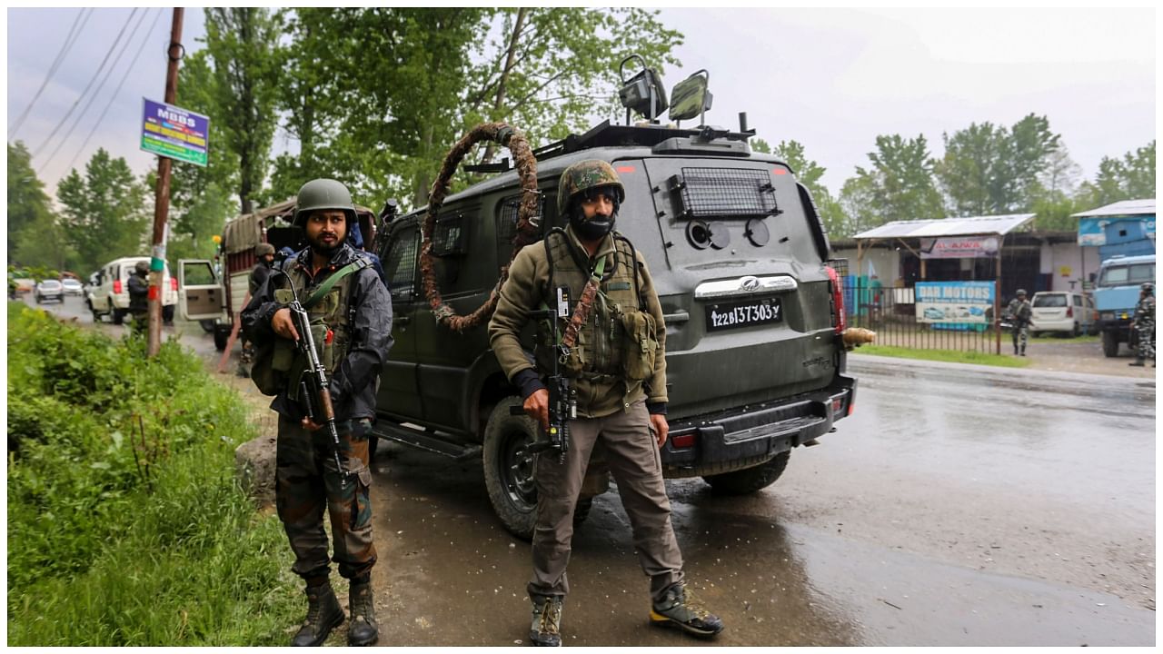 Security personnel stand guard amid a high alert in view of recent encounters with terrorists, ahead of the G20 meeting in J&K's Srinagar, in Baramulla district, Saturday, May 6, 2023. Credit: PTI Photo