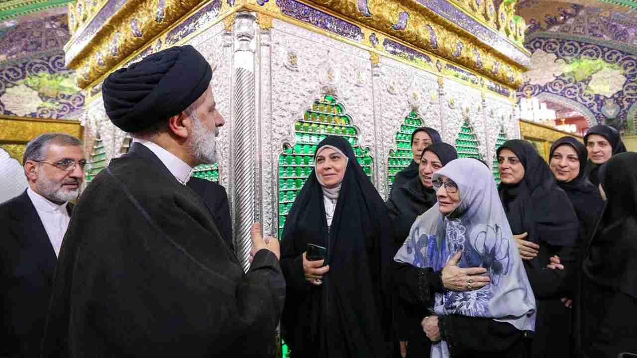 A handout picture provided by the Iranian presidency on May 4, 2023, shows Iranian President Ebrahim Raisi (L) greeting a group of women during his visit to the holy shrine of Sayyida Zaynab in the southern suburbs of Damascus. Credit: AFP Photo
