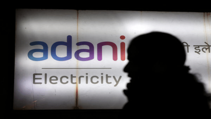 A woman walks past the Adani Electricity corporate office building in Mumbai, India, February 6, 2023. Credit: Reuters Photo