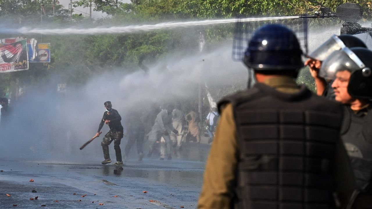 Police use a water cannon to disperse Pakistan Tehreek-e-Insaf (PTI) party activists and supporters of former Pakistan's Prime Minister Imran during a protest against the arrest of their leader in Lahore. Credit: AFP Photo