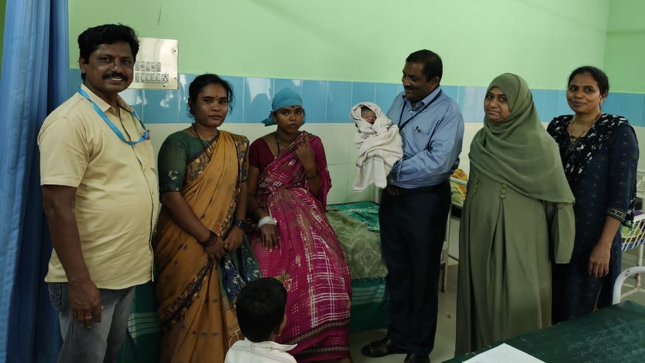 Block Election officer Venkatesh Ramachandra holds the child that was born at a polling booth in Korlagundi village, in Kurugodu taluk, Ballari district on Wednesday.  photo by special arrangements. Credit: Special arrangement