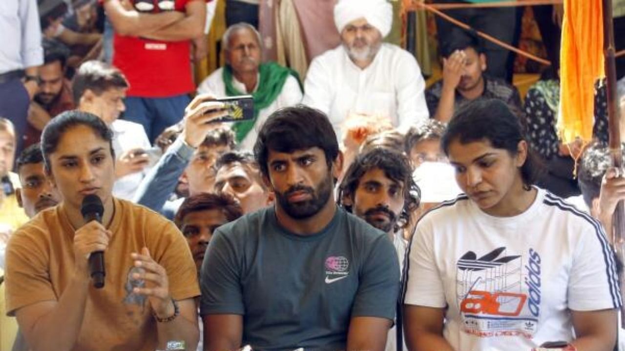 Wrestlers Bajrang Punia, Vinesh Phogat and Sakshi Malik at the site of the protest. Credit: IANS Photo
