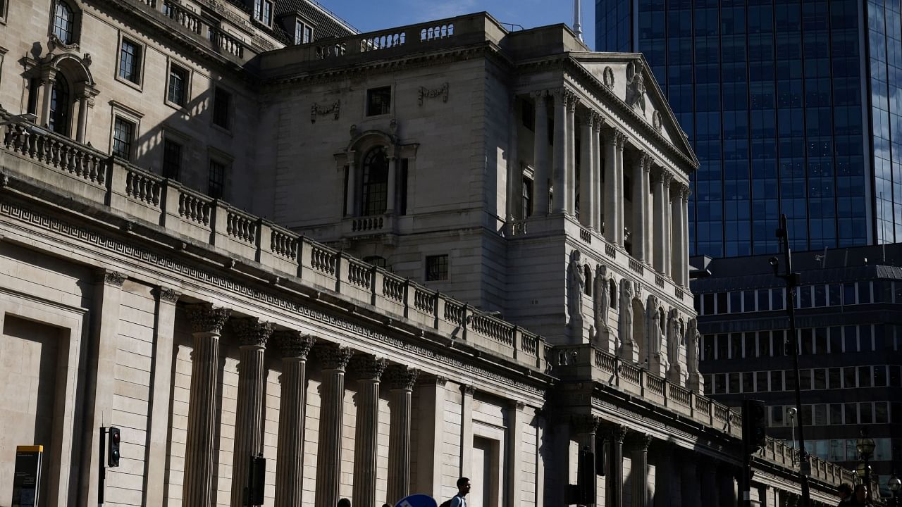 People walk outside the Bank of England in the City of London financial district in London. Credit: Reuters Photo