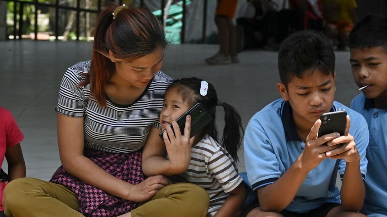 A girl evacuated by the Indian army during the ethnic riots in Manipur state reunites with her mother (L) at a temporary shelter at the Leimakhong Army Cantonment in the northeastern Indian state of Manipur on May 10, 2023. Credit: AFP Photo