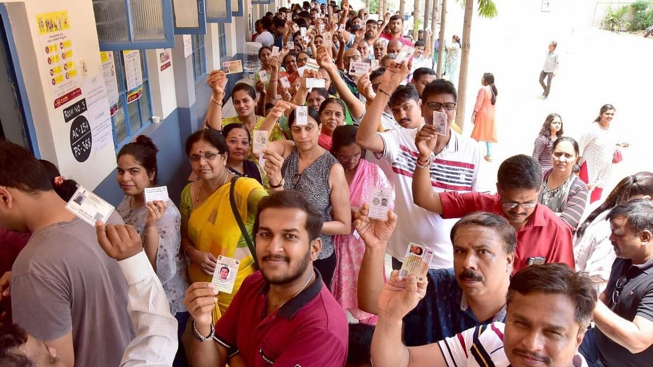 Voters stand in a queue to cast their vote, at a polling booth during the Karnataka Legislative Assembly election 2023 , in Bengaluru, on Wednesday, May 10, 2023. Credit: IANS Photo