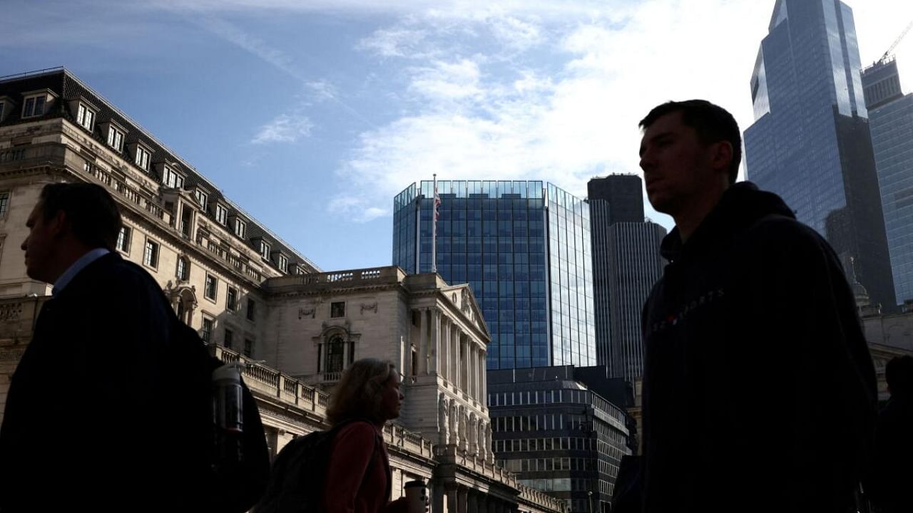 People walk outside the Bank of England in the City of London financial district in London, Britain. Credit: Reuters Photo