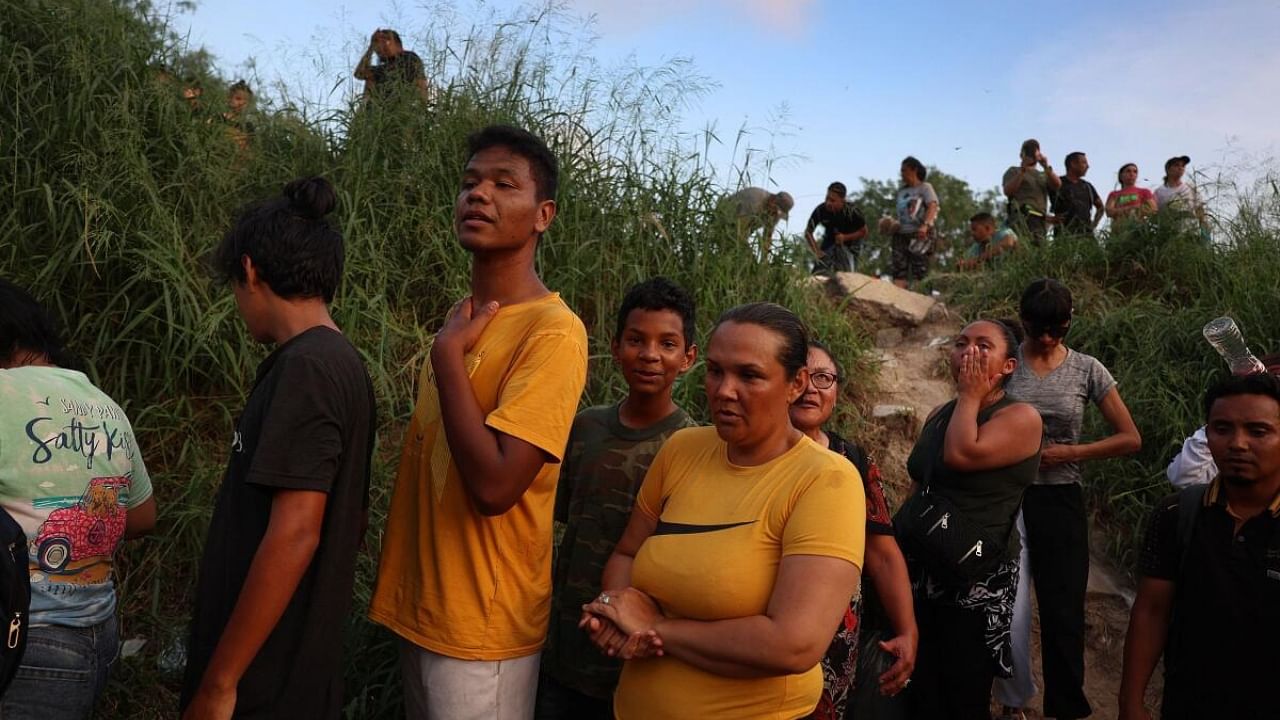 Migrants make their way down an embankment to the Rio Grande as they prepare to enter the United States on May 11, 2023 in Matamoros, Mexico. Credit: Getty Images/AFP