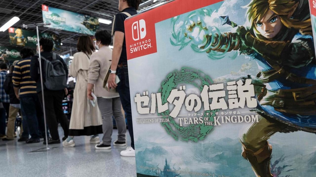 People (L) queue up at the check-out counter as dozens of shoppers arrived early at a popular electronics chain store for the latest offering from Japanese gaming giant Nintendo's long-running 'Legend of Zelda' game series - 'Tears of the Kingdom' - which went on sale in Tokyo on May 12, 2023. Credit: AFP Photo