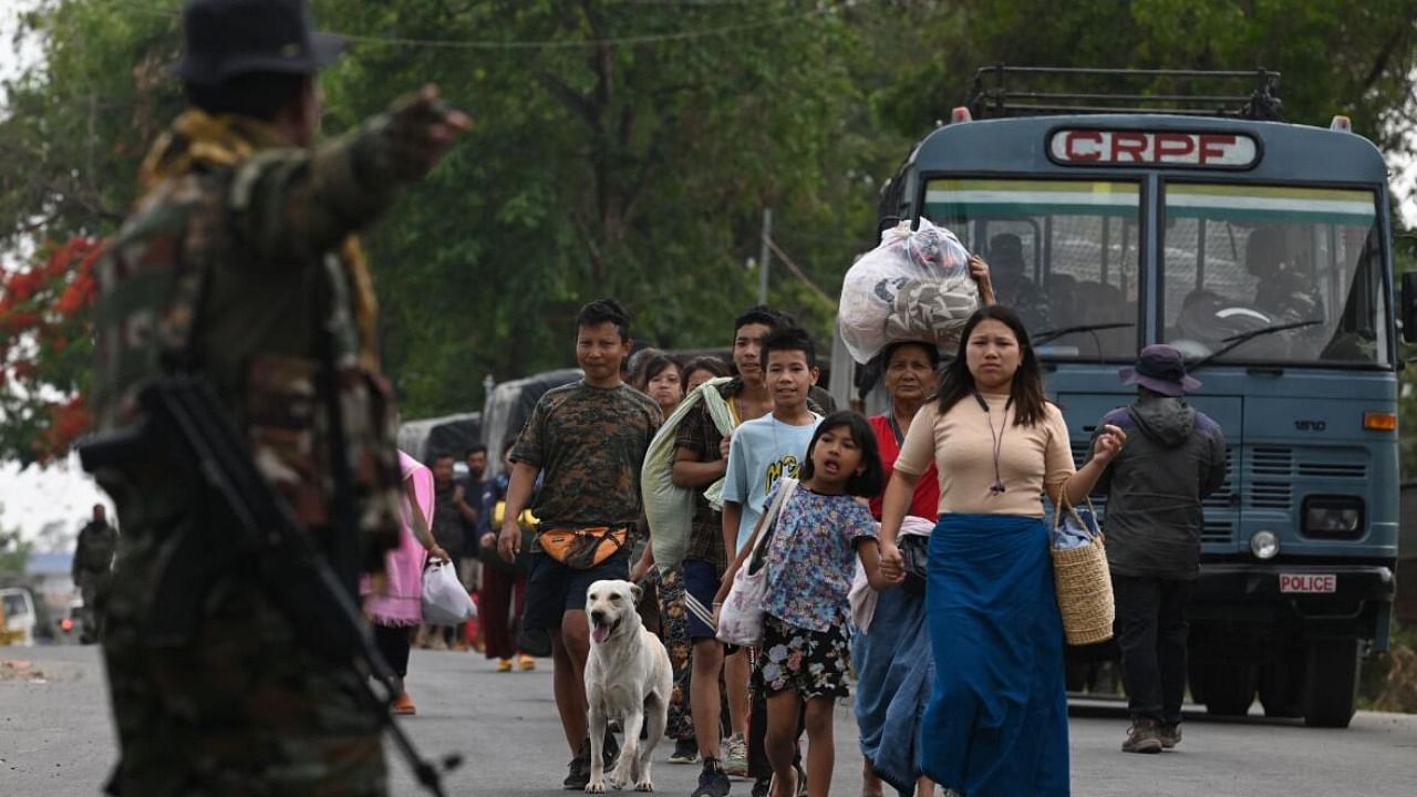 Meitei refugees arrive to board a paramilitary truck at a transit point after being evacuated from the violence that hit Churachandpur, near Imphal. Credit: PTI Photo