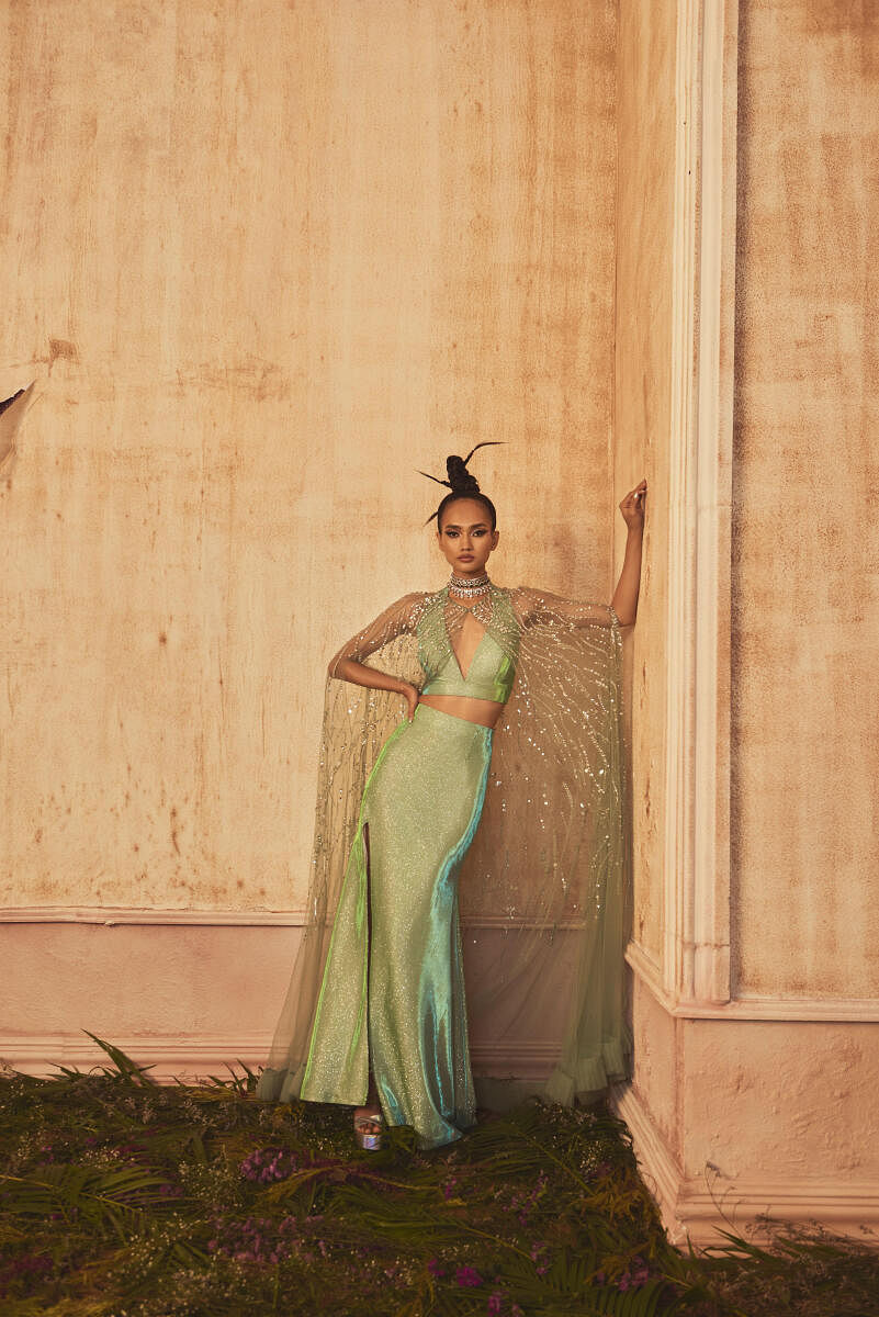 An ensemble by Shivani Awasty, with a shimmering subtle sea green cape.
