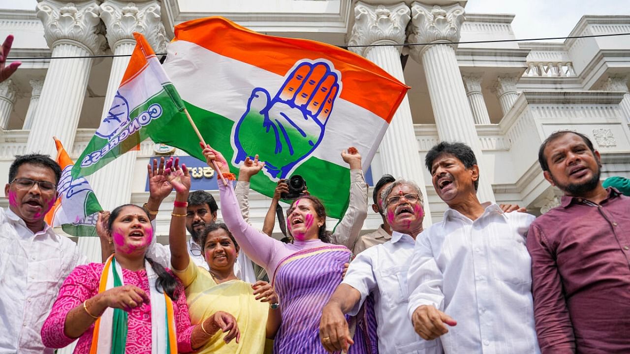 Congress leaders and workers celebrate at the party office as the party leads in early trends on the vote counting day of Karnataka Assembly polls, in Bengaluru, Saturday, May 13, 2023. Credit: PTI Photo