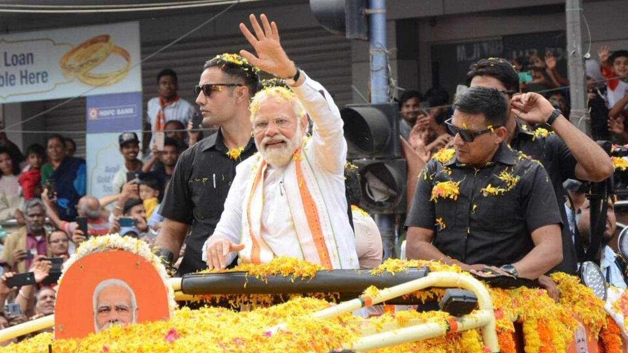 Prime Minister Narendra Modi during a roadshow at CMH Road ahead of the Karnataka assembly polls, in Bengaluru on Sunday, May 07, 2023. Credit: IANS Photo