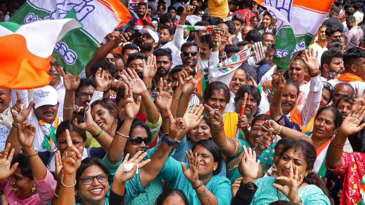 Congress supporters celebrate the party's win in the Karnataka Assembly elections, in Bengaluru. credit: PTI Photo