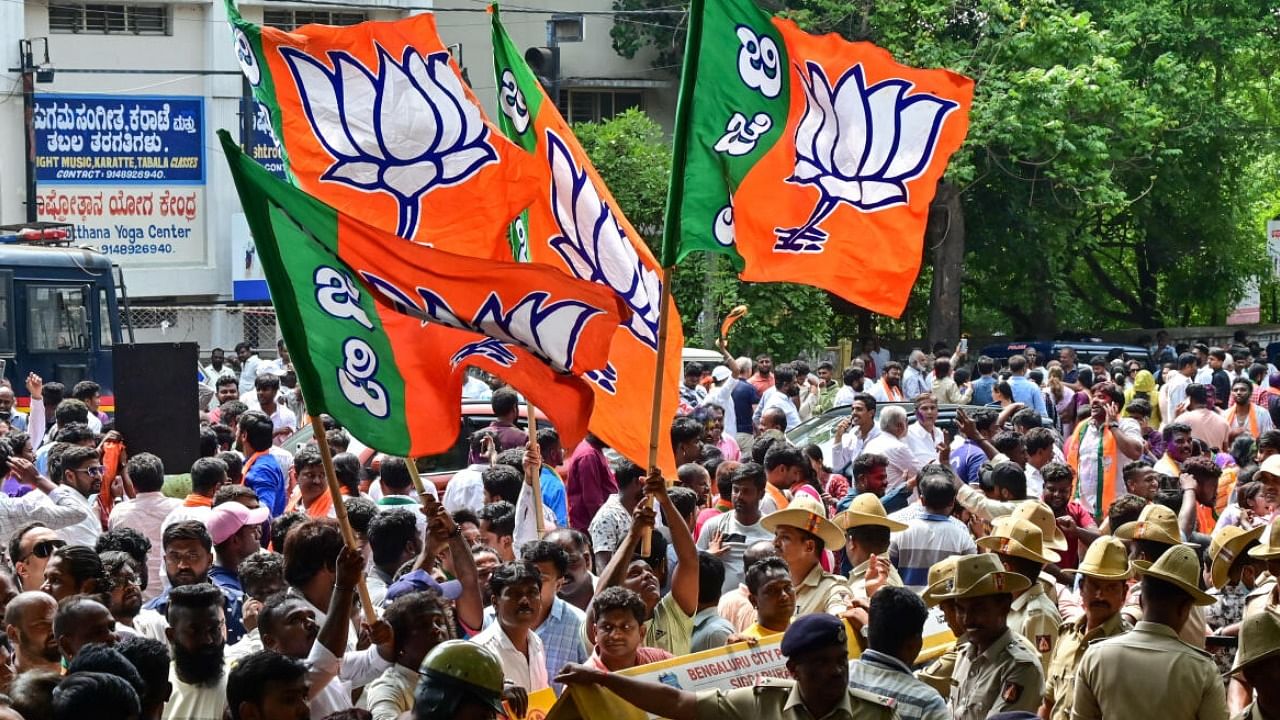 BJP workers break into a dance outside a counting centre in Basavanagudi. DH PHOTO/Prashanth H G