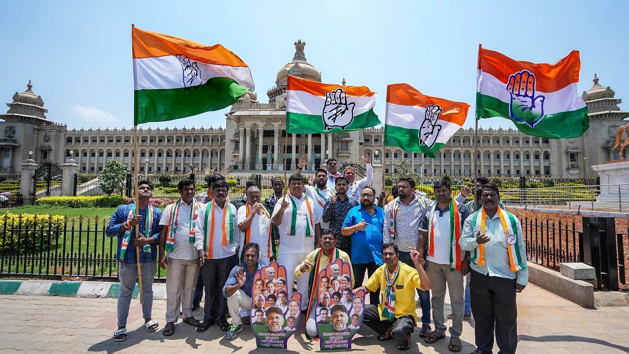 Congress workers celebrate the party's win in Karnataka Assembly elections. Credit: PTI Photo