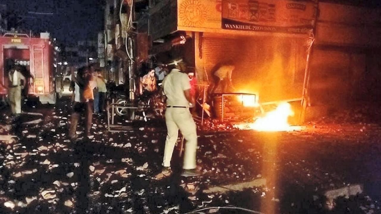 Police and other security personnel attempt to maintain law and order after a clash broke out between members of two communities over a social media post, in Akola. Credit: PTI Photo