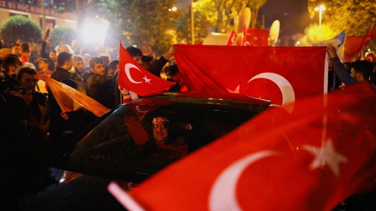 People react following early exit poll results for the presidential and parliamentary elections, in Istanbul. Credit: Reuters Photo