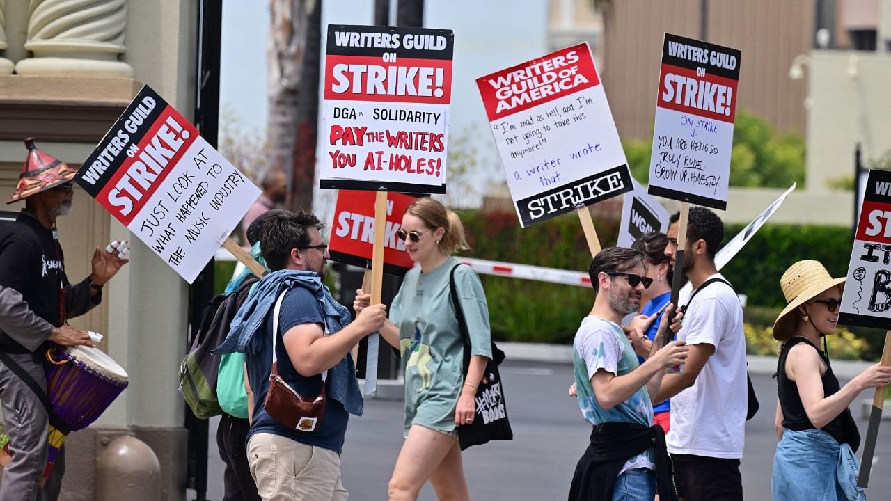Writers hold signs while picketing in front of Paramount Studios in Los Angeles, California. Credit: AFP Photo