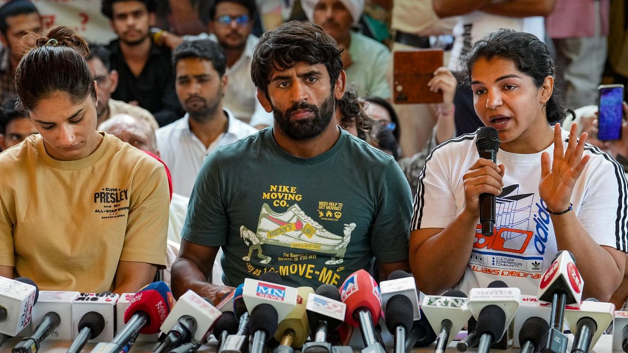 Wrestlers Bajrang Punia, Vinesh Phogat and Sakshi Malik address the media during their protest against Wrestling Federation of India chief Brij Bhushan Sharan Singh. Credit: PTI Photo