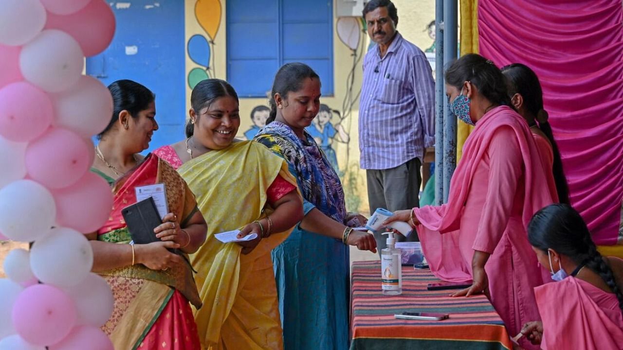 Women arrive at the pink polling booth set-up for female voters to cast their ballot during the Karnataka state assembly election in Bengaluru. Credit: PTI Photo