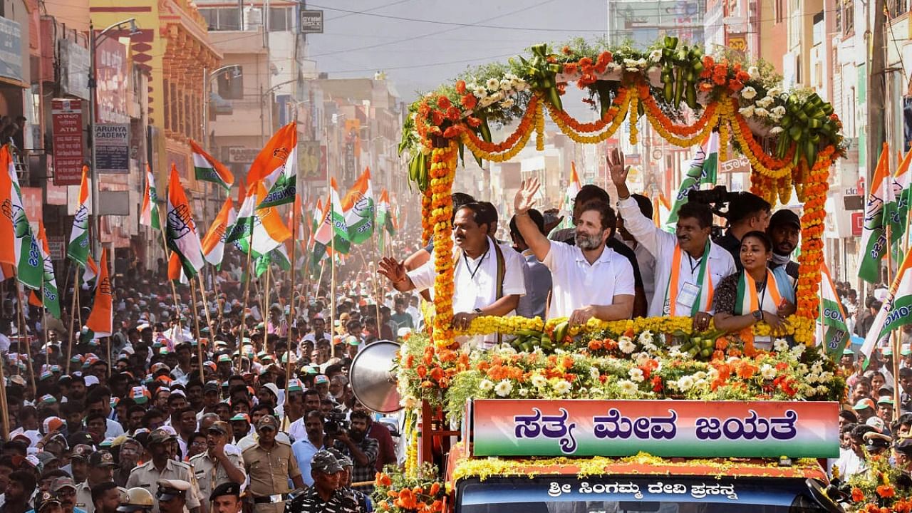 Congress leader Rahul Gandhi waves at supporters during a roadshow ahead of Assembly elections, in Chikmagalur, Tuesday, May 2, 2023. Credit: PTI Photo