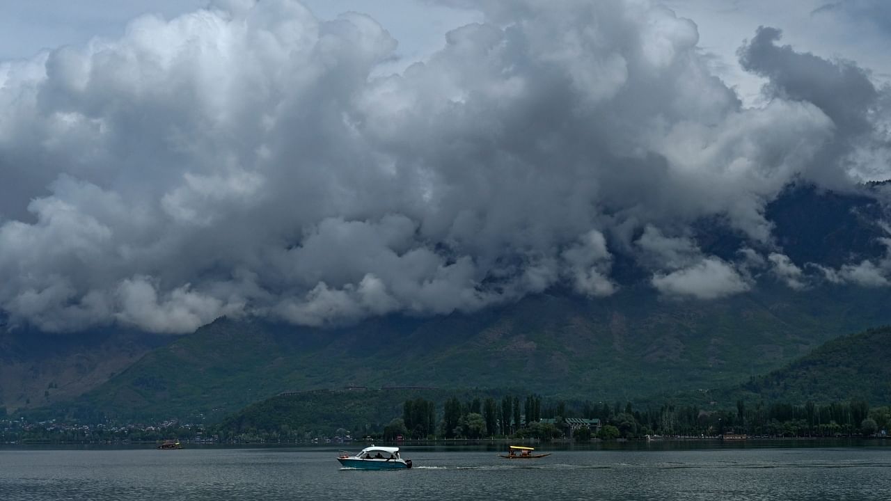 Tourists enjoy motor boat ride at Dal Lake in Srinagar on May 3, 2023. Credit: AFP File Photo