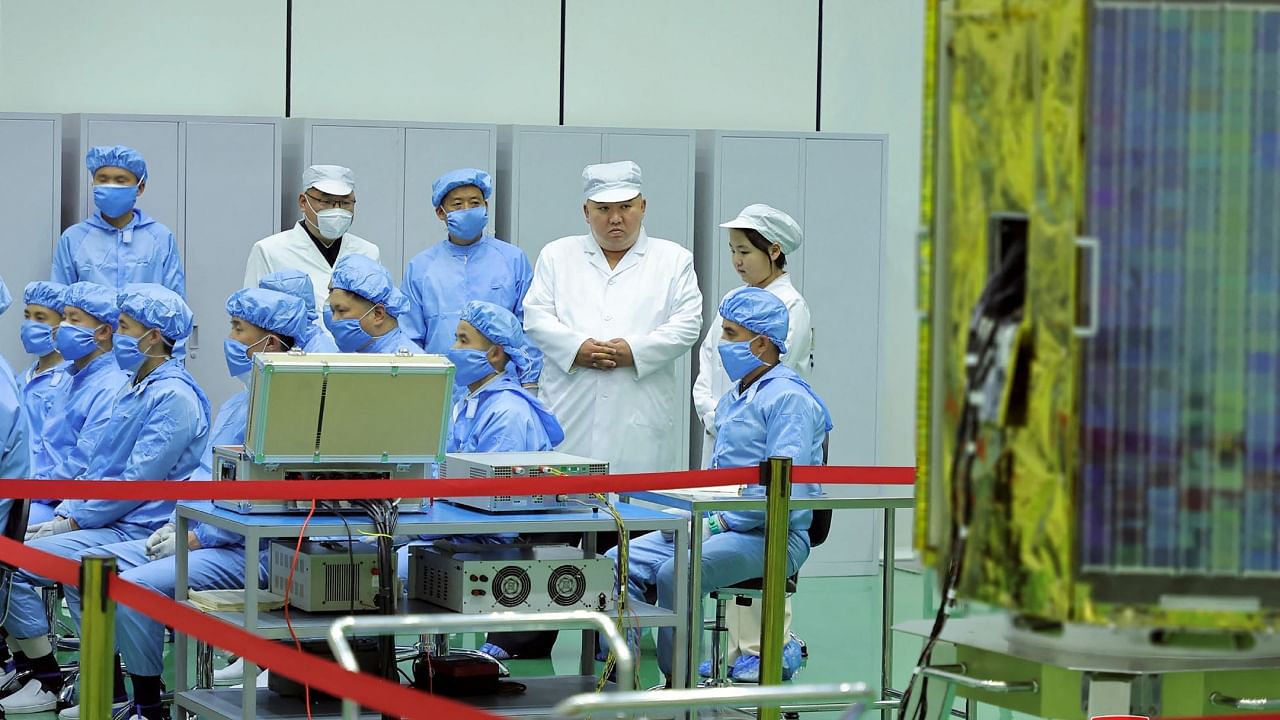 This picture shows Kim Jong-un and his daughter inspecting a militay reconnaissance satellite, at an undisclosed location in North Korea, May 16, 2022. Credit: AFP Photo/KCNA via KNS