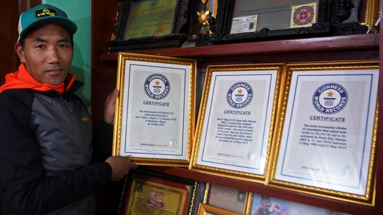 Nepal's mountaineer Kami Rita Sherpa poses with his Guinness World Record certificates. Credit: AFP File Photo