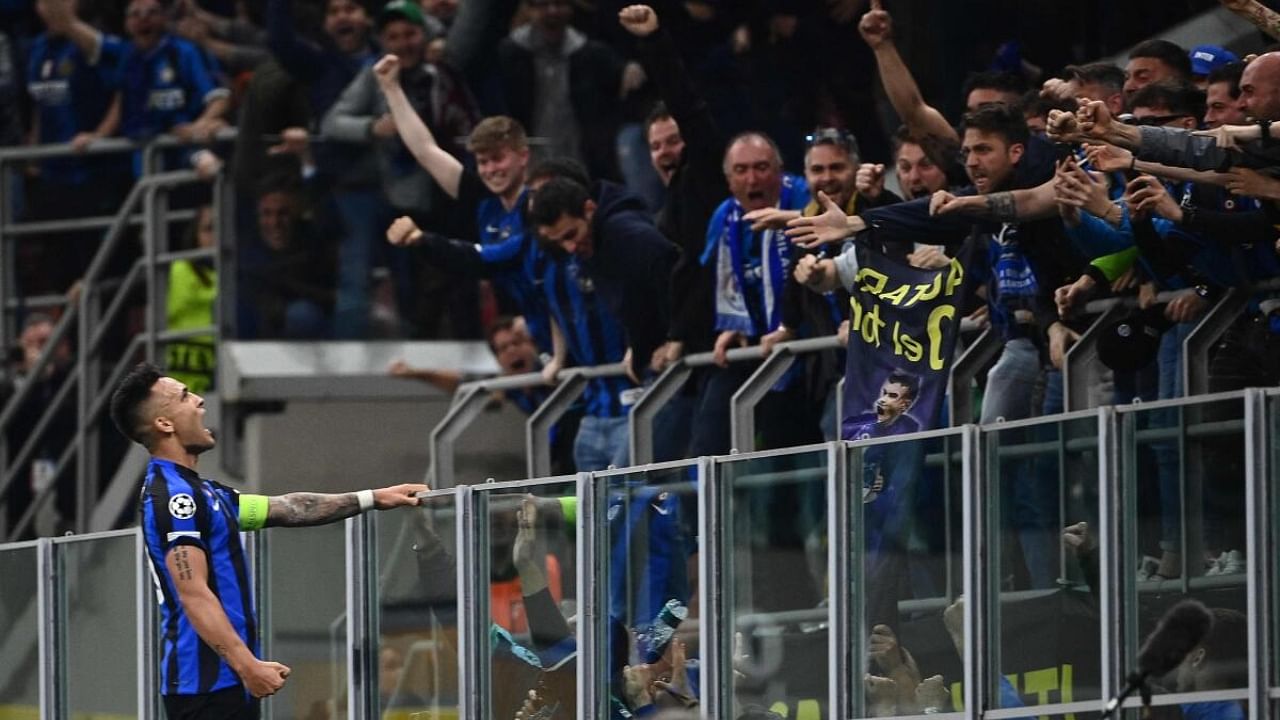 Inter Milan's Argentinian forward Lautaro Martinez (L) celebrates after opening the scoring during the UEFA Champions League semi-final second leg football match between Inter Milan and AC Milan on May 16, 2023 at tyhe Giuseppe-Meazza (San Siro) stadium in Milan. Credit: AFP Photo