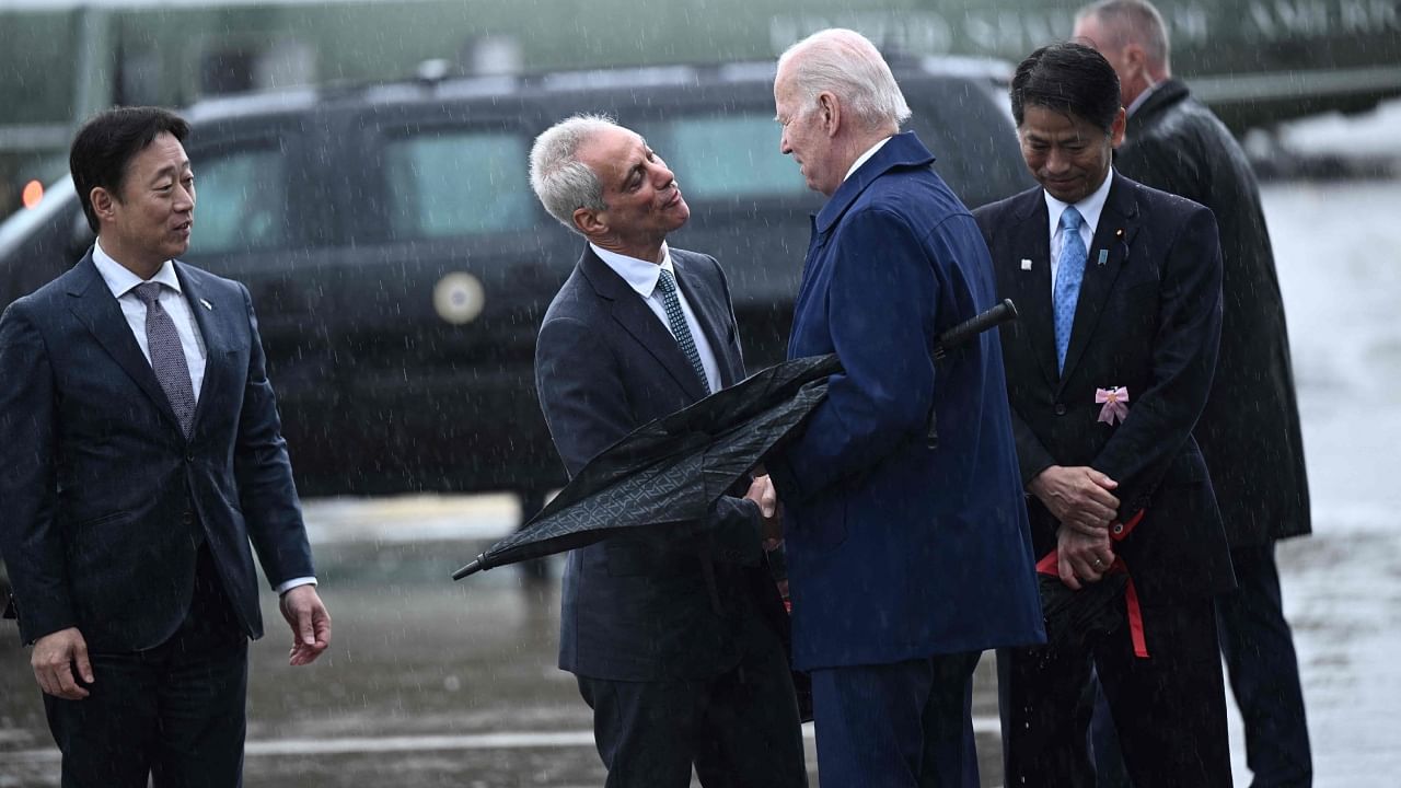 US President Joe Biden (C) shakes hands with US Ambassador to Japan Rahm Emanuel (C) upon his arrival at the US Marine Corps base in Iwakuni on May 18, 2023, ahead of the G7 Leaders' Summit in Hiroshima. Credit: AFP Photo