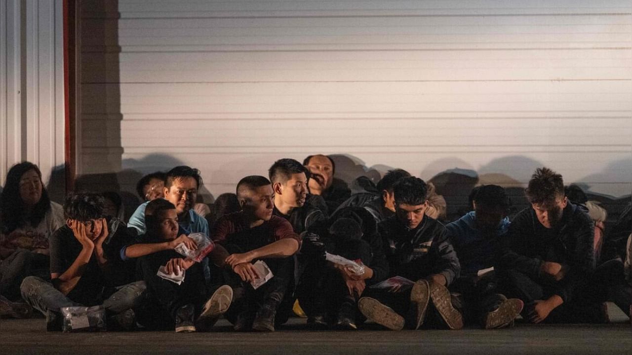 Migrants wait for a bus to take them to a processing center after they turned themselves over to US Border Patrol agents after crossing over from Mexico in Fronton, Texas. Credit: AFP Photo