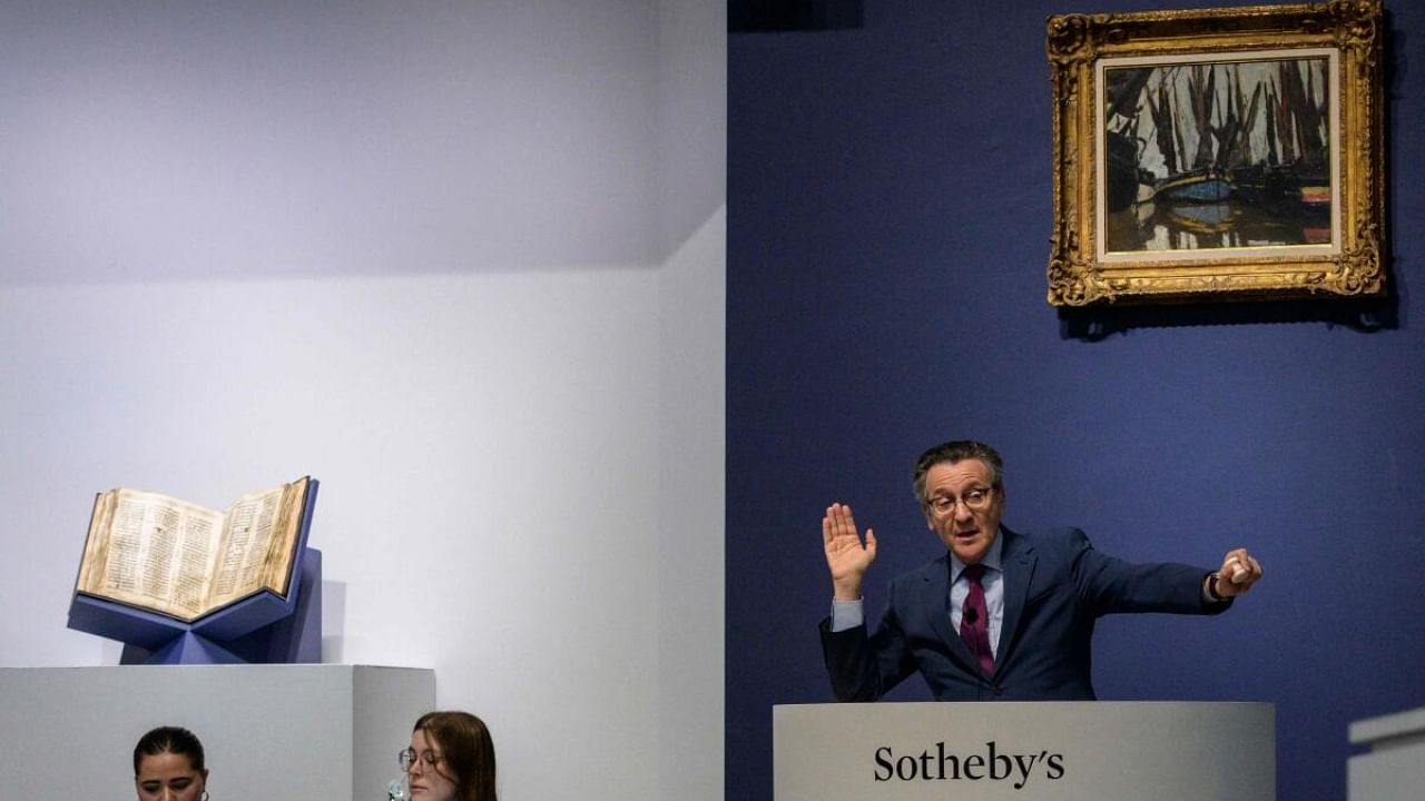 Sotheby’s auctioneer Benjamin Doller takes bids during the Codex Sassoon sale at Sotheby’s in New York City on May 17, 2023. Credit: AFP Photo