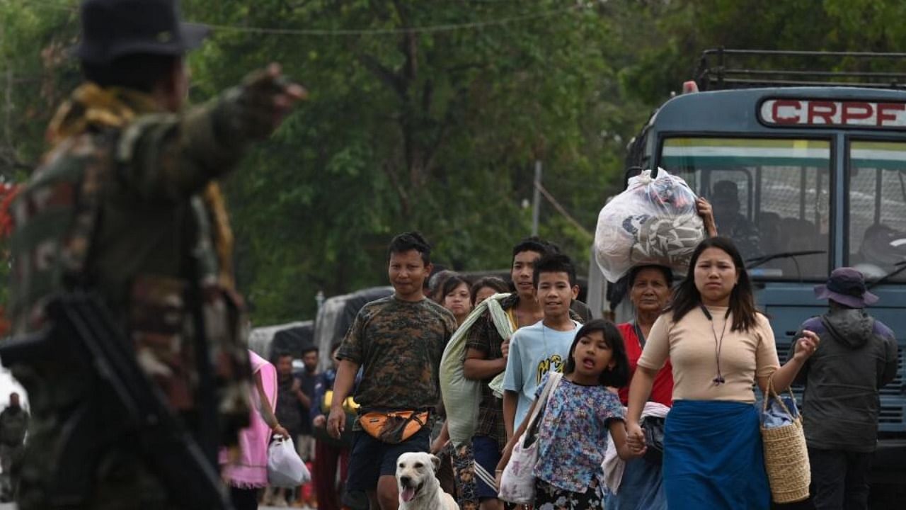 Meitei refugees arrive to board a paramilitary truck at a transit point after being evacuated from the violence that hit Churachandpur, near Imphal in Manipur on May 9, 2023. Credit: AFP Photo