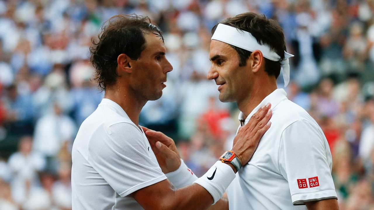 Switzerland's Roger Federer (R) shakes hands and embraces Spain's Rafael Nadal (L) after Federer won their men's singles semi-final match on day 11 of the 2019 Wimbledon Championships. Credit: AFP Photo