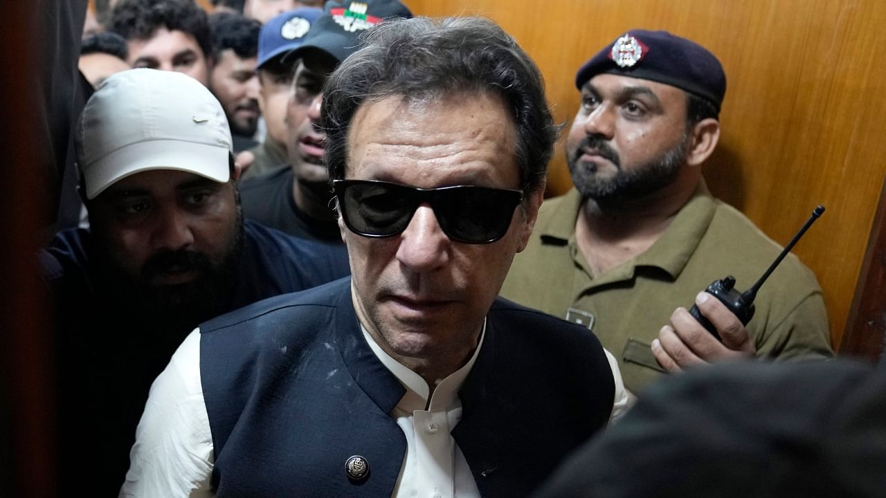 Former Pakistani Prime Minister Imran Khan, center, leaves after appearing in a court, in Lahore, Pakistan, Friday, May 19, 2023. Credit: AP/PTI Photo