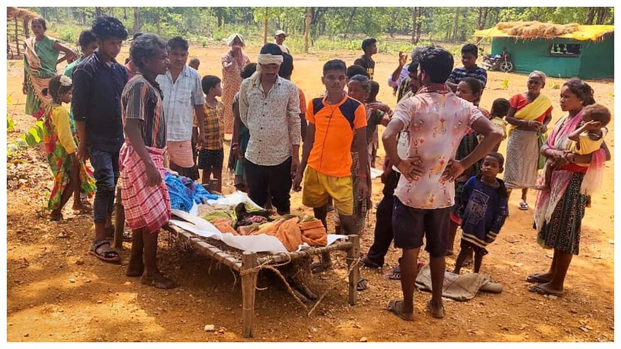Villagers gather near the body of a 10-year-old boy, who was killed when an Improvised Explosive Device (IED) allegedly planted by CPI (Maoists) exploded, in Jharkhand's West Singbhum district, Friday, May 19, 2023. Credit: PTI Photo