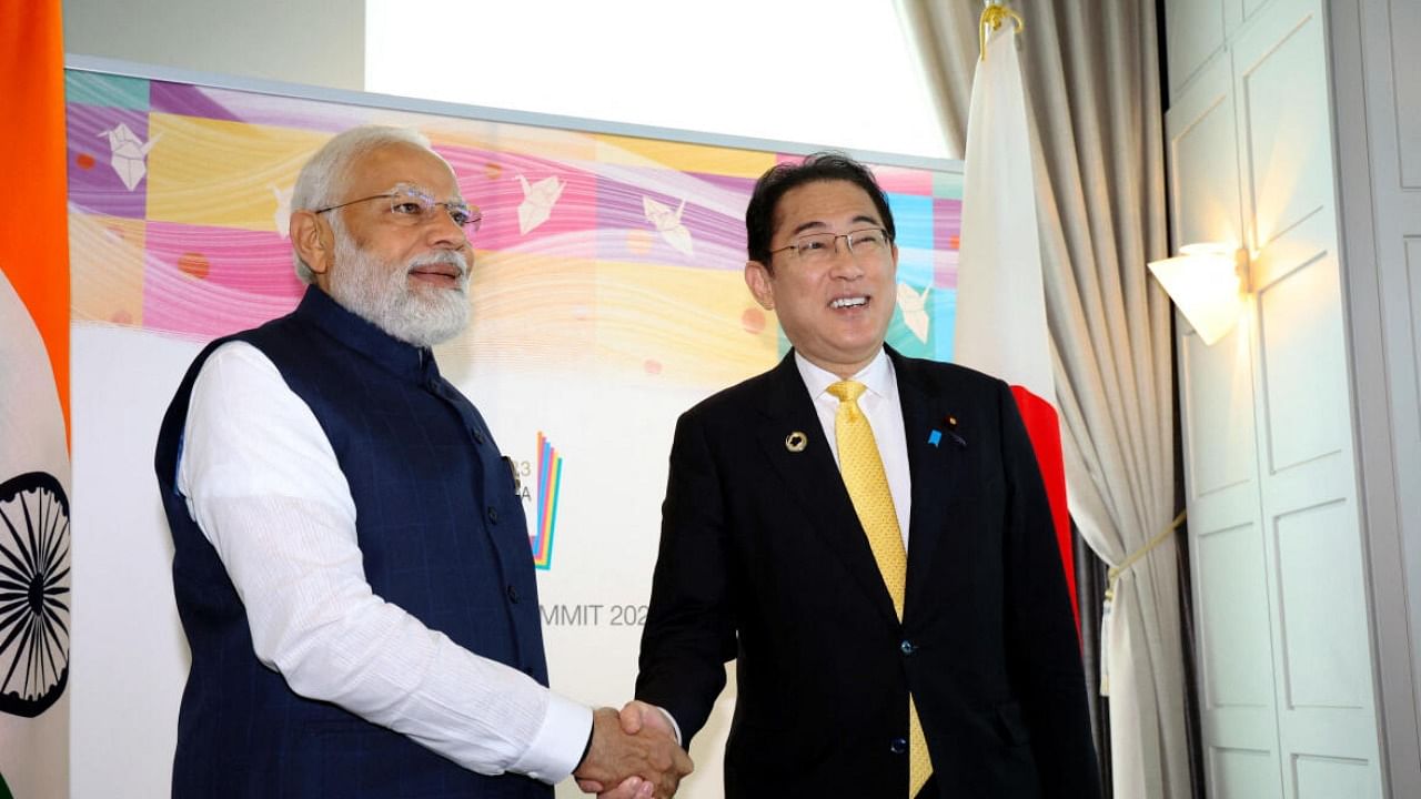 PM Narendra Modi shakes hands with Japan's PM Fumio Kishida during their bilateral meeting on the sidelines of the G7 Summit Leaders' Meeting in Hiroshima. Credit: AFP Photo