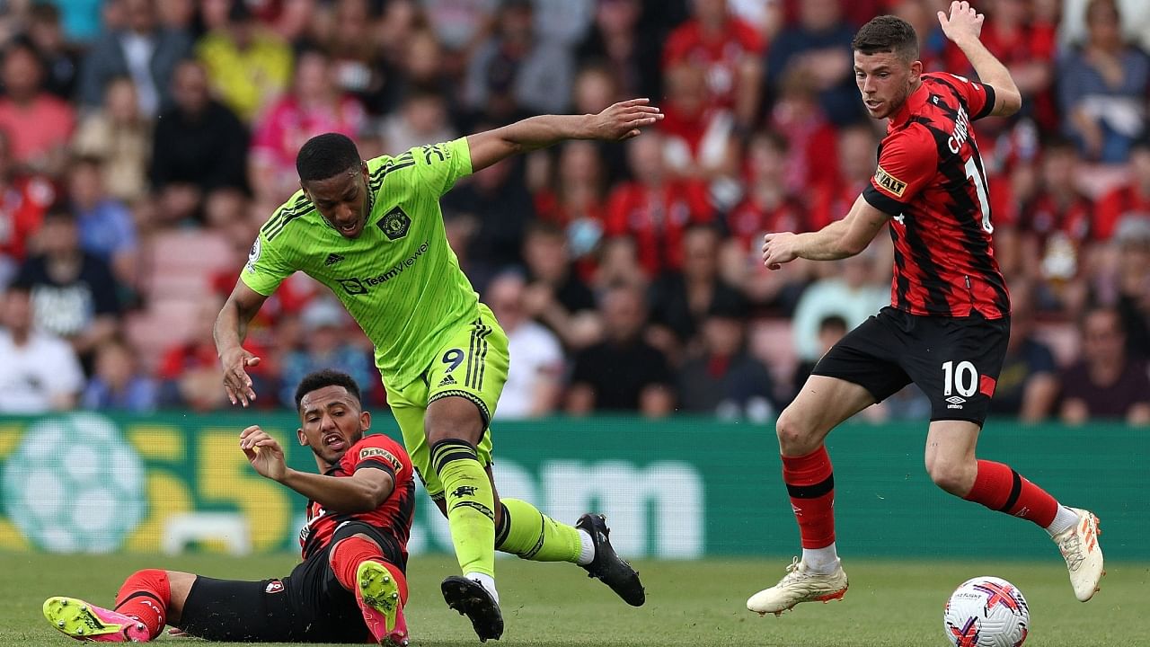 Manchester United's French striker Anthony Martial (C) challenges Bournemouth's English defender Lloyd Kelly (L) and Bournemouth's Scottish midfielder Ryan Christie (R) during the English Premier League football match. Credit: AFP Photo