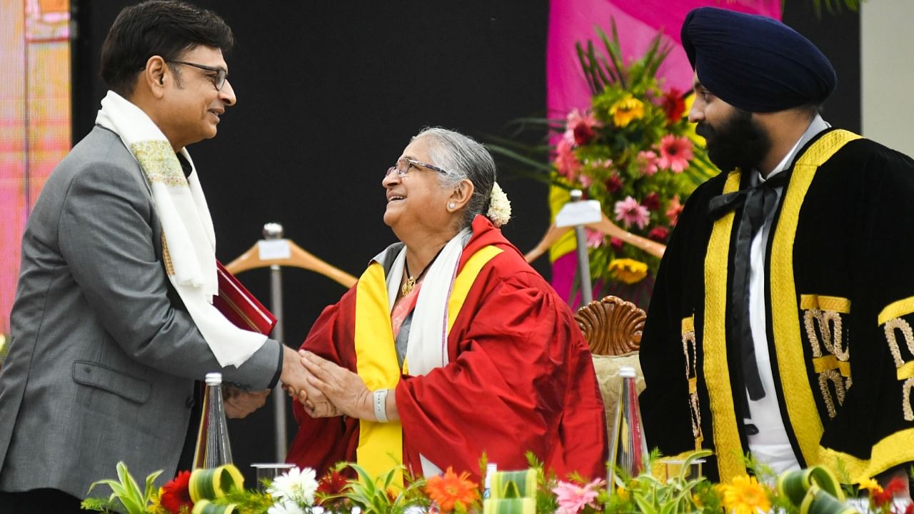 Writer Sudha Murthy congratulates Bollywood writer Irshad Kamil after receiving the Sahitya Ratna Award during the 70th convocation of Panjab University, in Chandigarh. Credit: PTI Photo