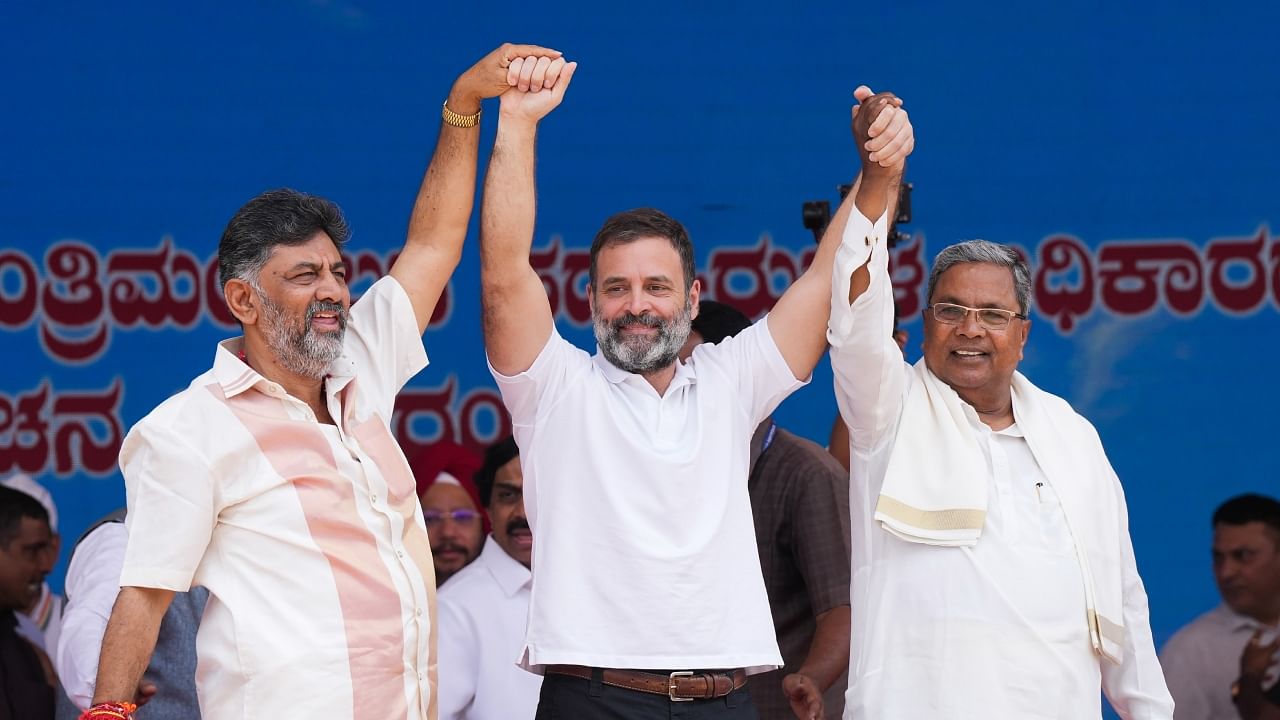 Rahul Gandhi with D K Shivakumar (L) and Siddaramaiah (R) during the oath-taking ceremony in Bengaluru, May 20, 2023. Credit: PTI Photo