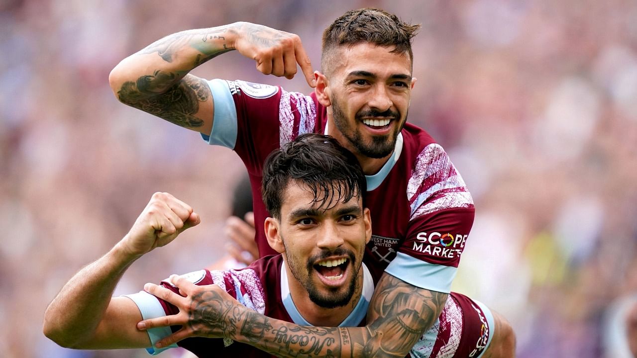 West Ham United's Manuel Lanzini, top, celebrates with teammate Lucas Paqueta after scoring his side's third goal of the game, during the English Premier League soccer match between West Ham United and Leeds United, at the London Stadium. Credit: AP Photo