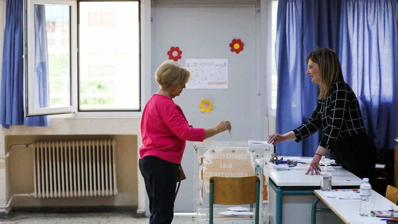 A woman casts her vote at a polling station, during the general election, in Athens, Greece. Credit: Reuters Photo