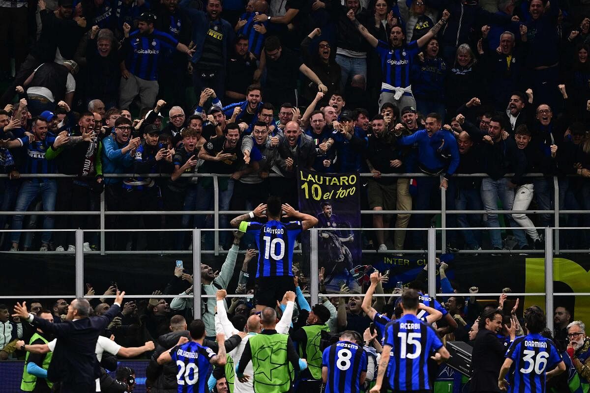 Inter Milan's Argentinian forward Lautaro Martinez (C) celebrates after opening the scoring during the UEFA Champions League semi-final second leg against AC Milan. Credit: AFP Photo