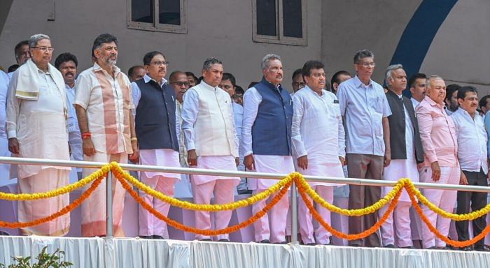 Chief Minister Siddaramaiah (first from left) and Deputy CM D K Shivakumar (second from left) with the new ministers at the oath-taking ceremony in Bengaluru on Saturday. Credit: DH Photo/S K Dinesh 
