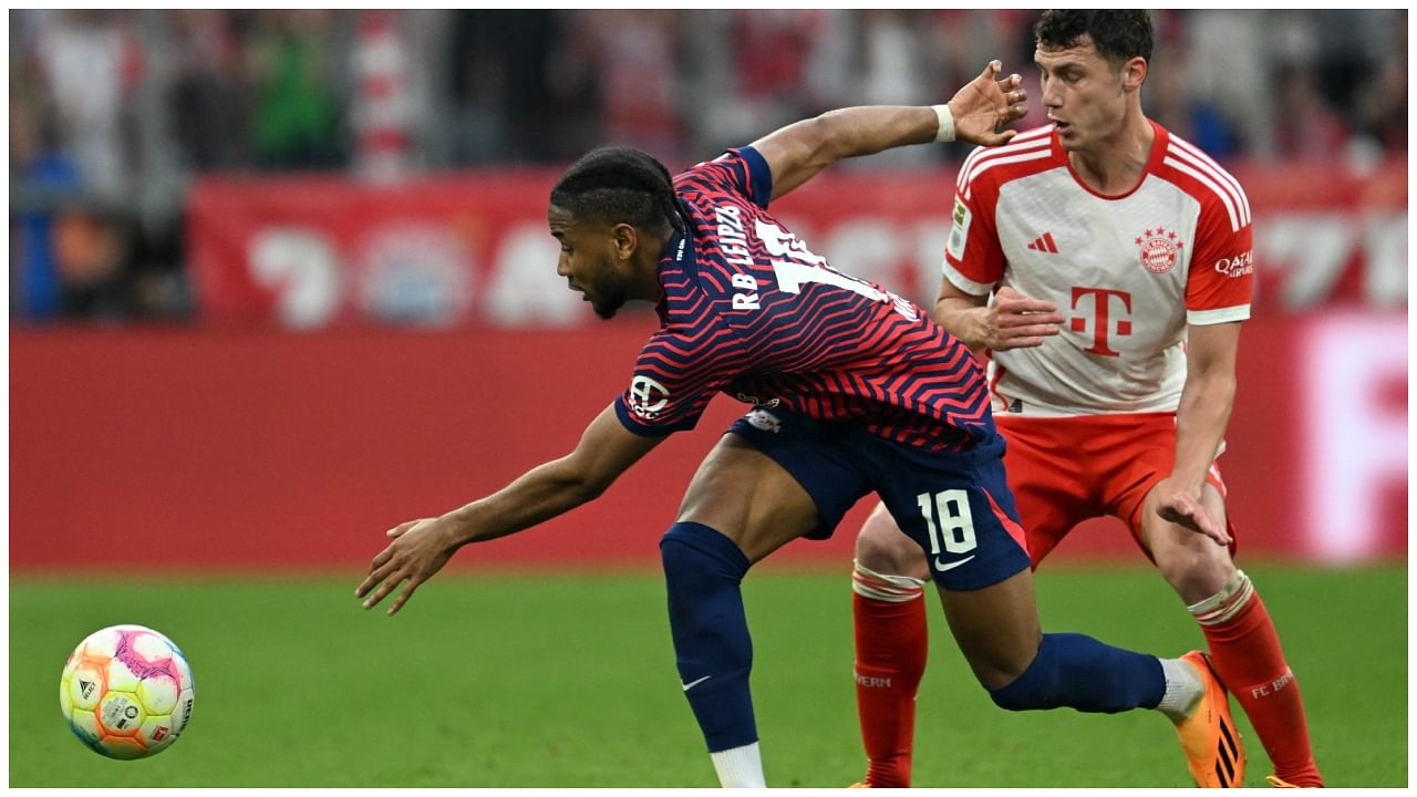 Bayern Munich's French defender Benjamin Pavard (R) and Leipzig's French striker Christopher Nkunku vie for the ball during the German first division Bundesliga football match between FC Bayern Munich and RB Leipzig in Munich. Credit: AFP Photo