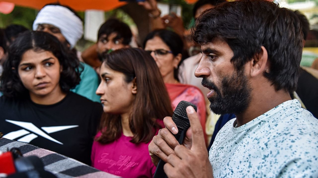 Wrestlers Vinesh Phogat, Bajrang Punia and Sakshi Malik address the media during their protest against WFI chief Brij Bhushan Sharan Singh. Credit: PTI Photo